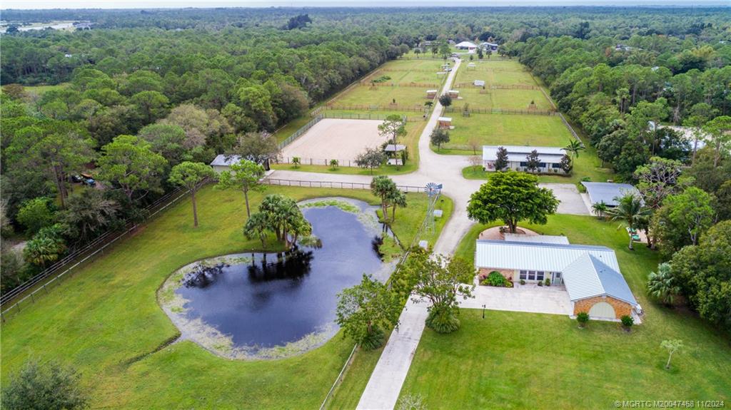 an aerial view of a house with a garden and lake view