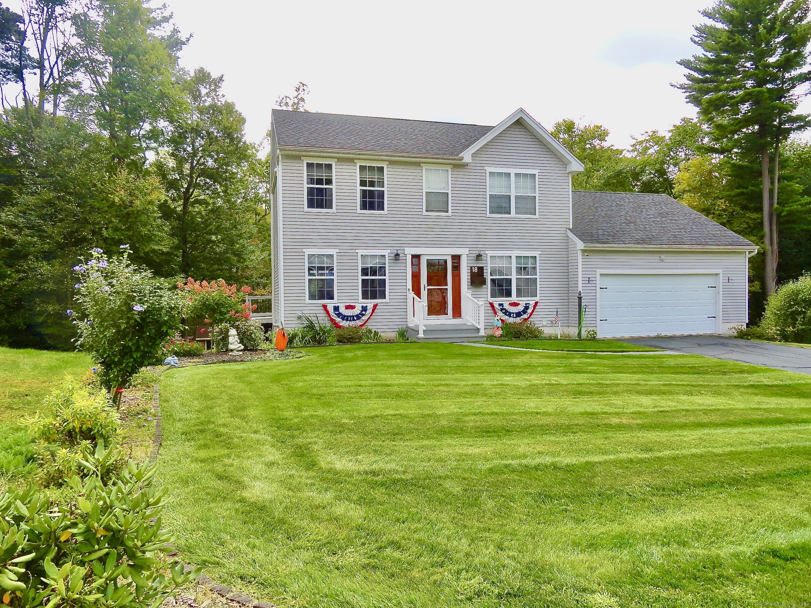 a front view of house with yard and outdoor seating