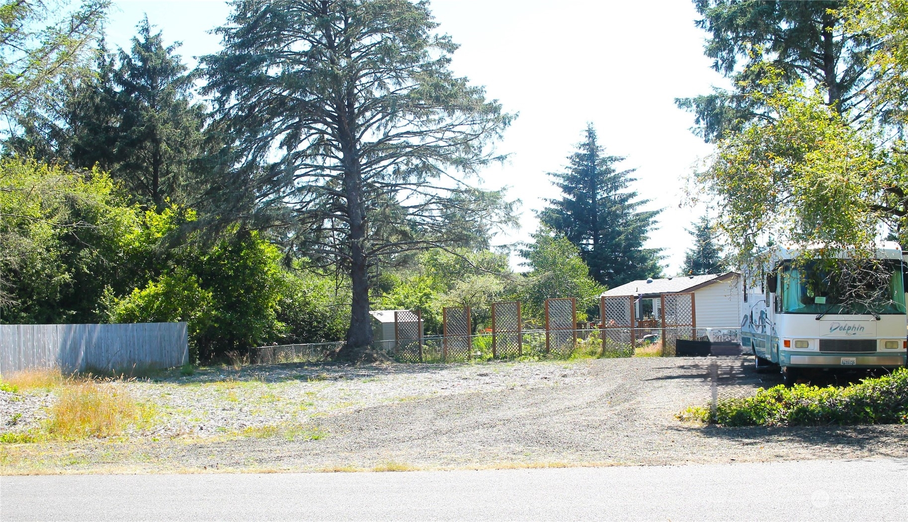 a view of a house with a yard and tree s