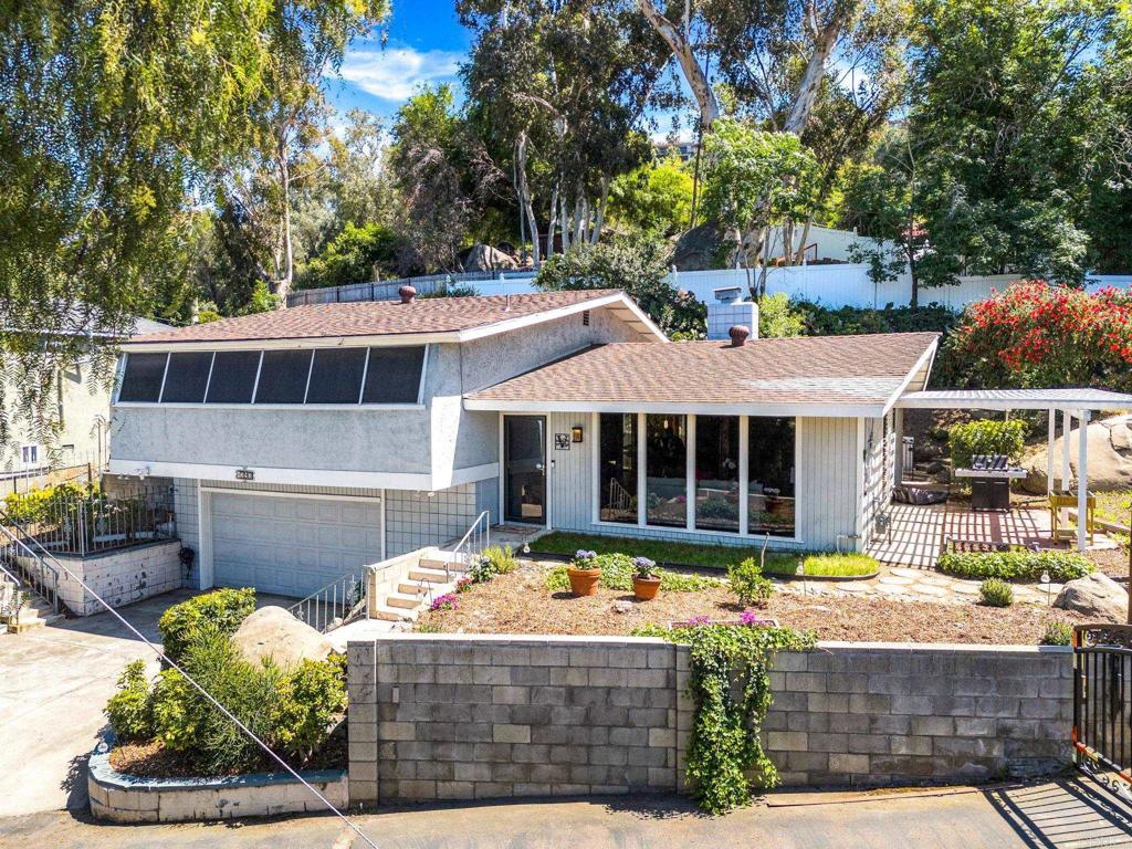 a front view of a house with a yard garage and outdoor seating