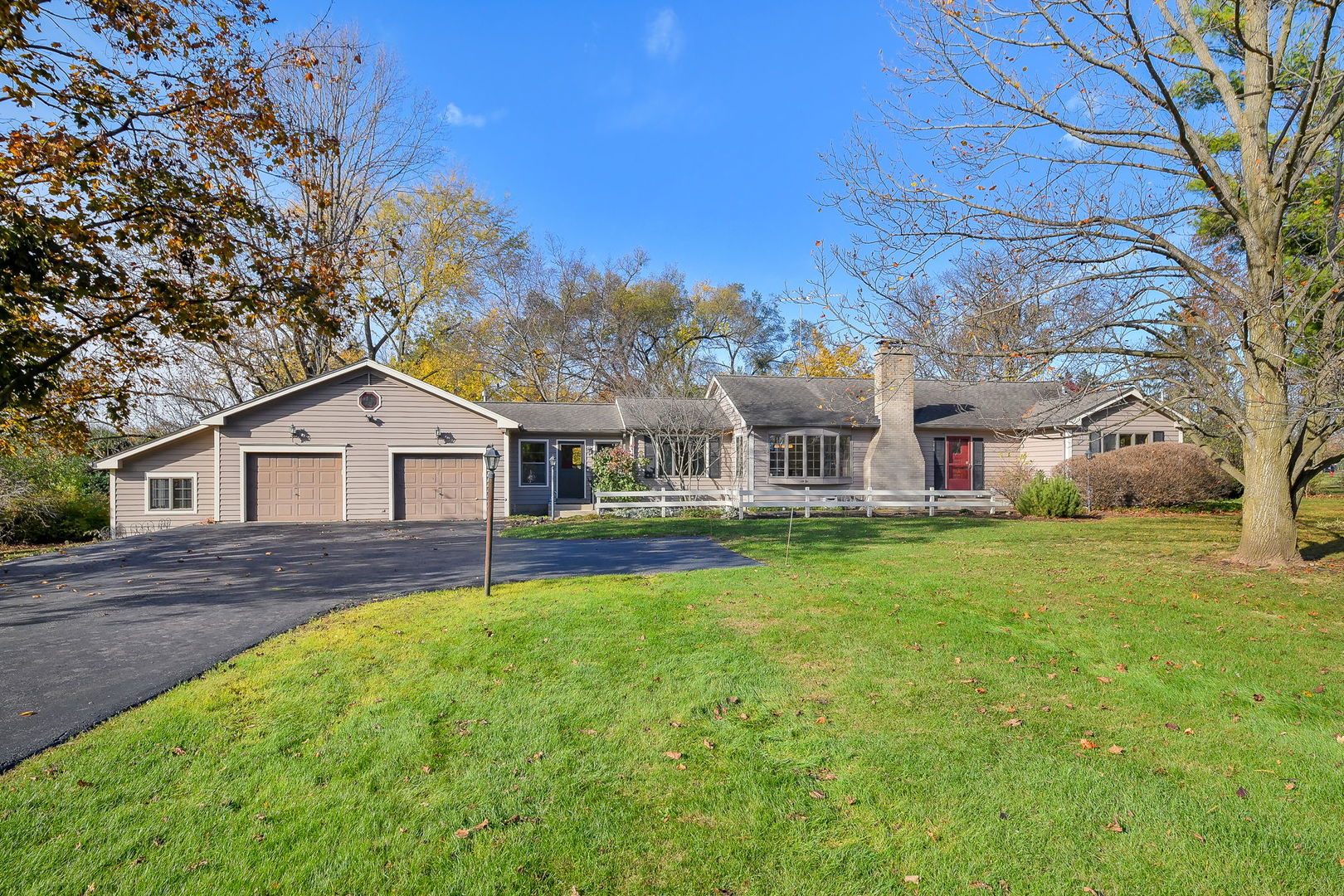 a front view of house with yard and trees