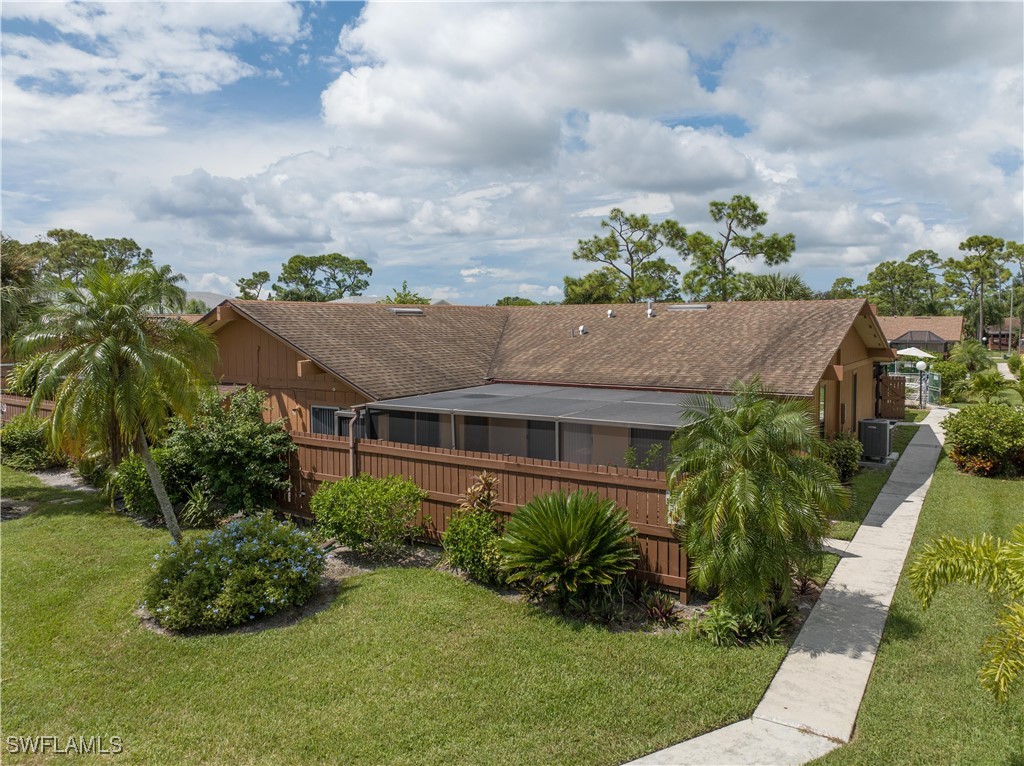 a aerial view of a house with a yard and potted plants