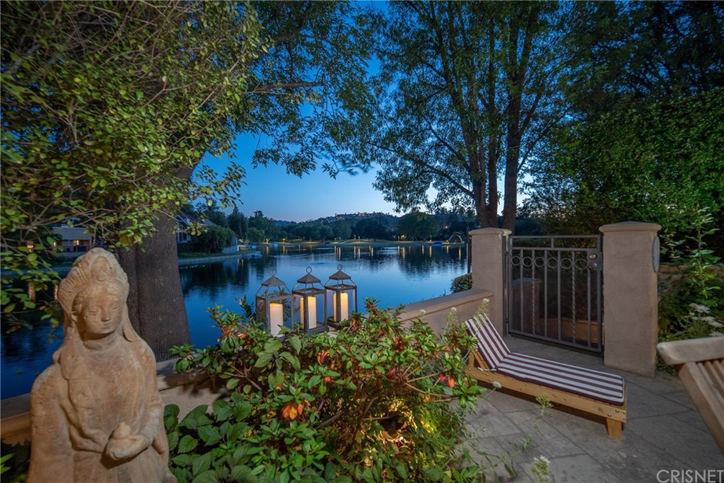 a view of a lake with sitting area and garden