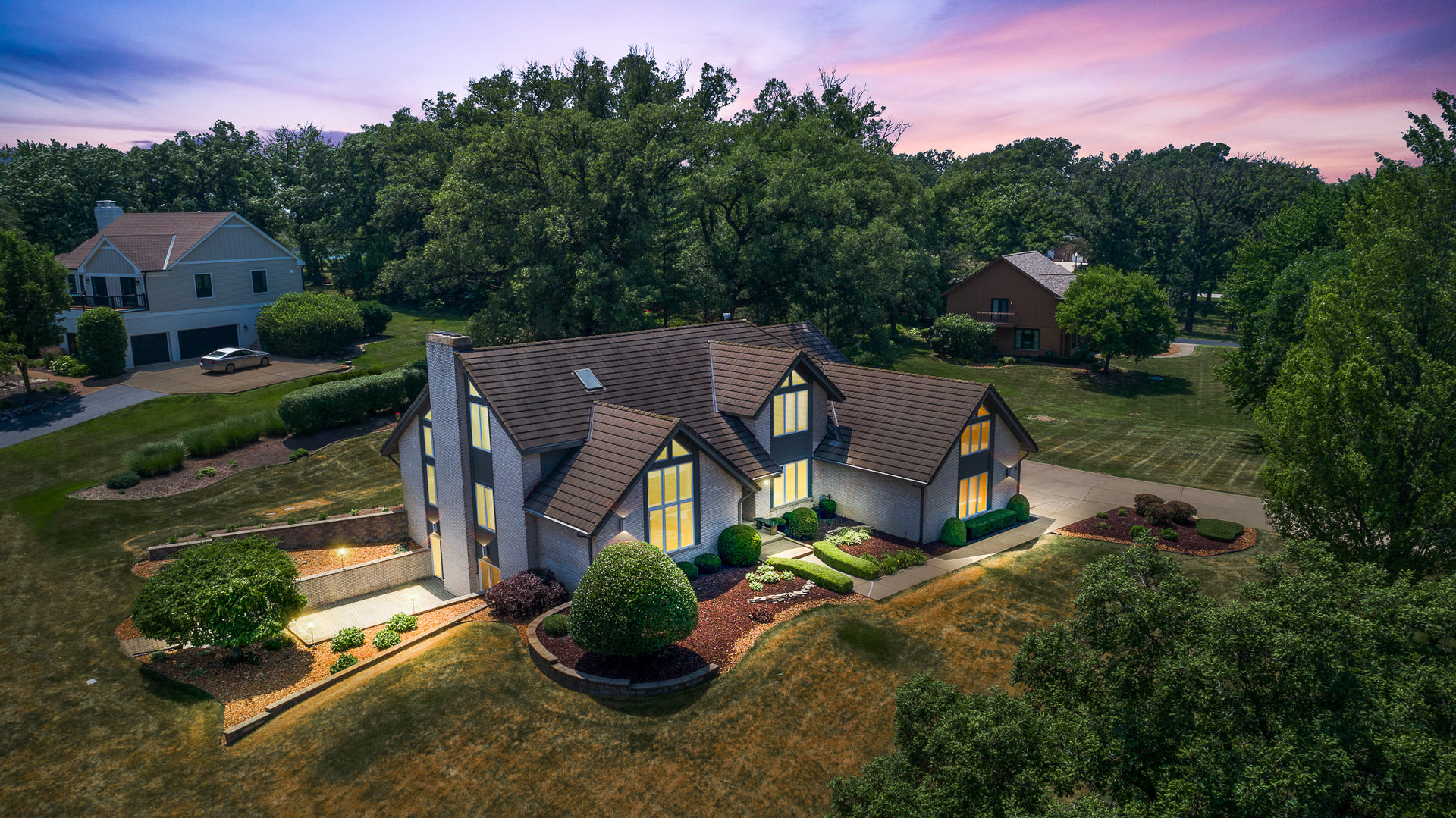 an aerial view of a house with garden space and street view