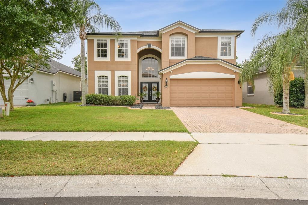 a front view of a house with a yard and garage