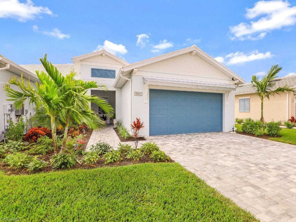 a front view of a house with a yard and a garage