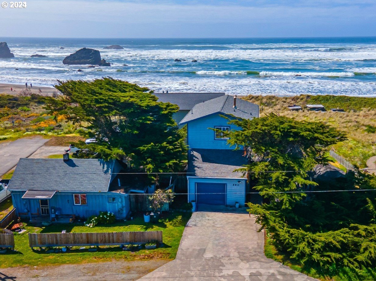 a view of a house with a yard and ocean view