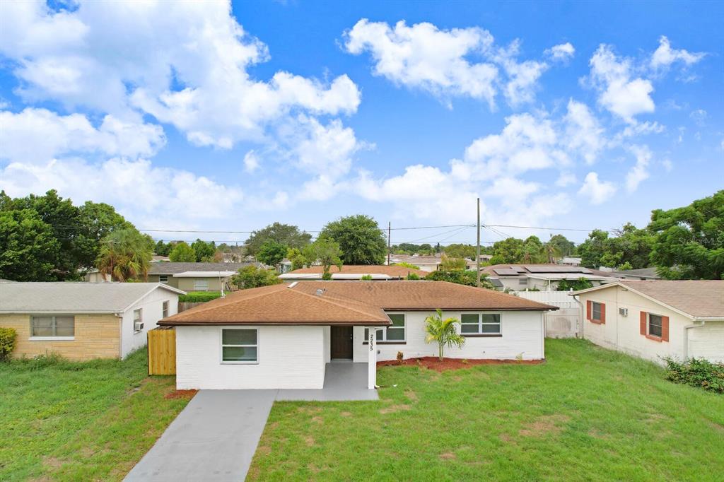 a aerial view of a house with a yard