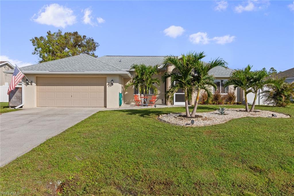 a view of a house with swimming pool and a yard