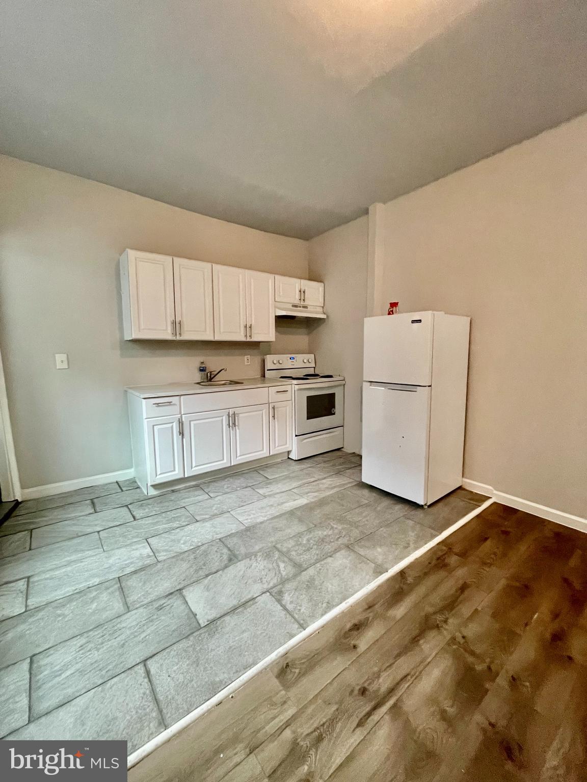 a view of kitchen with microwave and cabinets