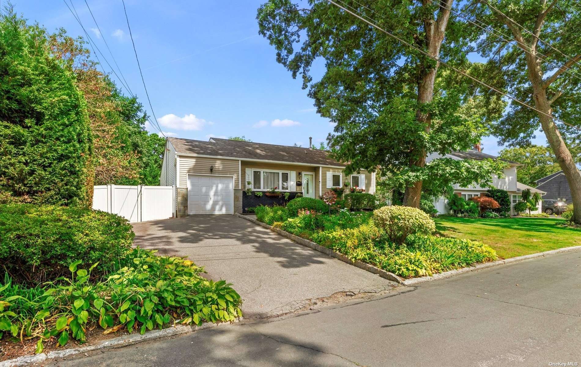 a front view of a house with a yard and potted plants