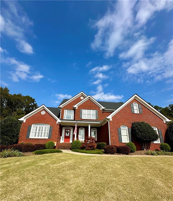 a front view of a house with a yard