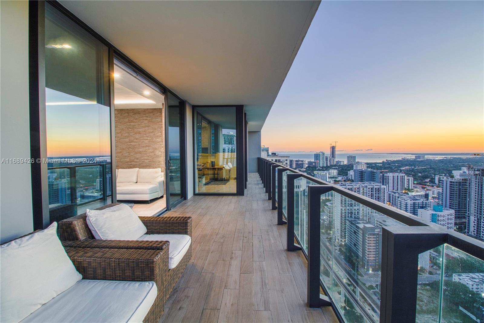 a view of a balcony with furniture and city view