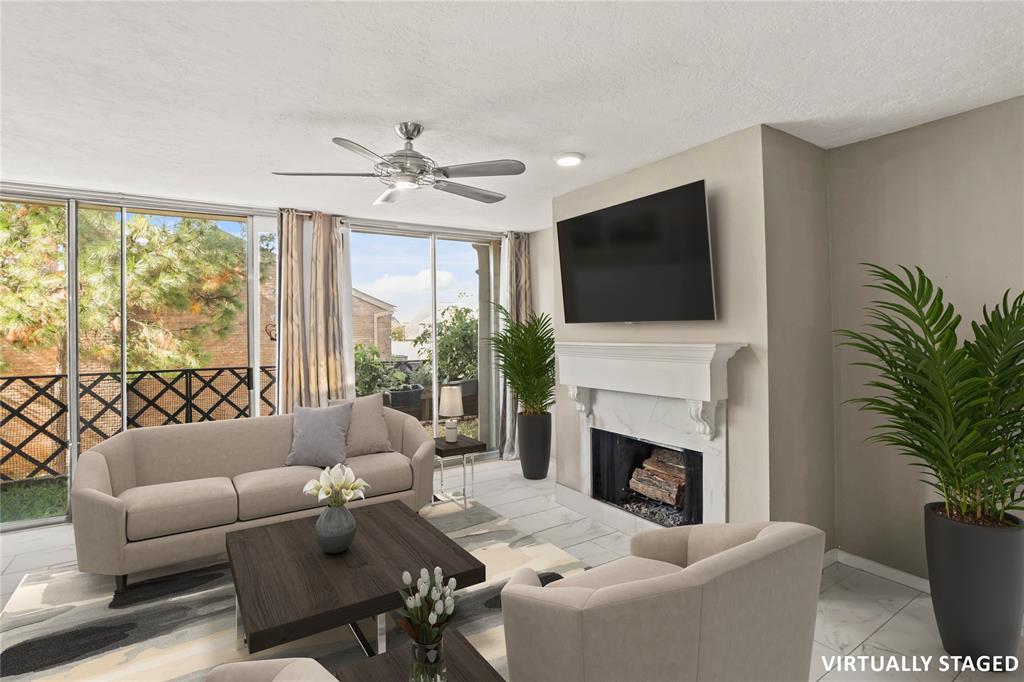 a living room with furniture a fireplace and a flat screen tv