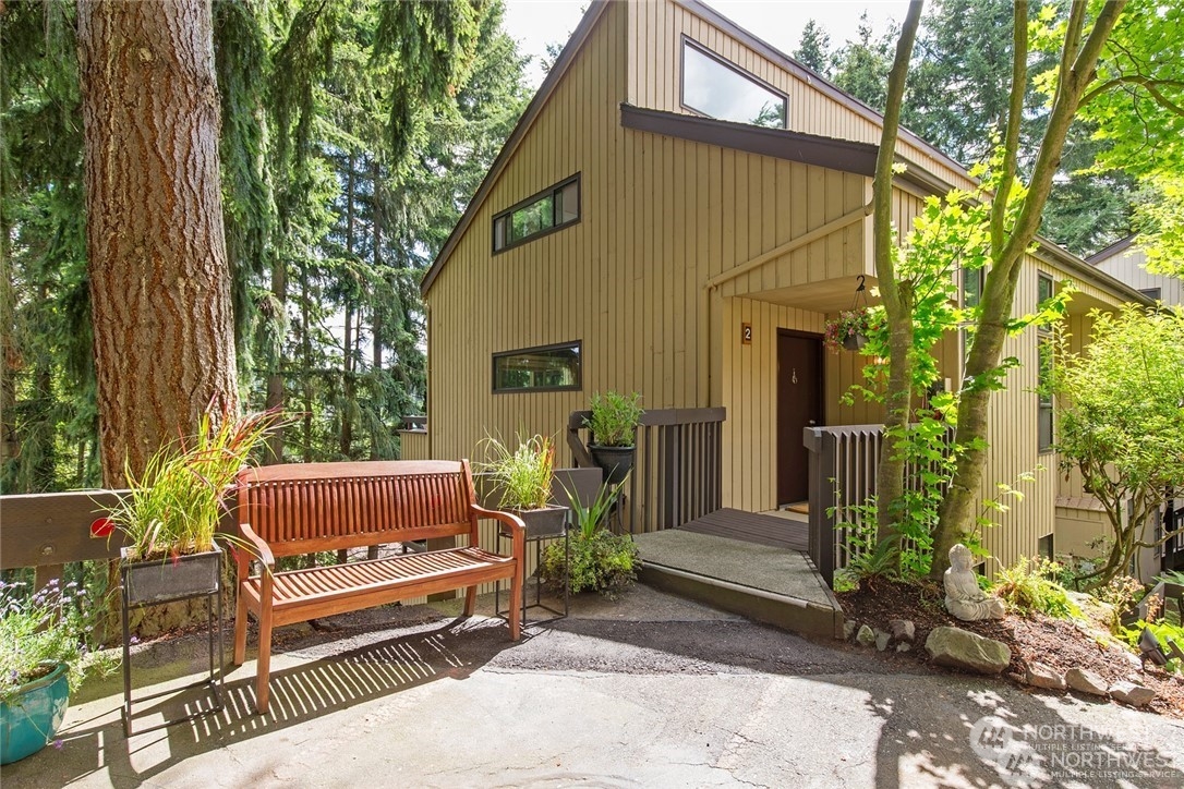 a wooden bench sitting in front of a house