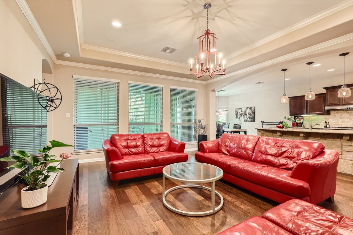 a living room with furniture and a chandelier