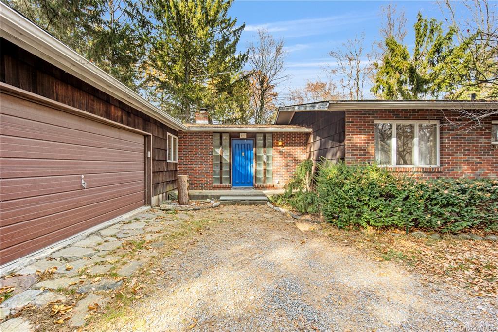 View of exterior entry with a garage