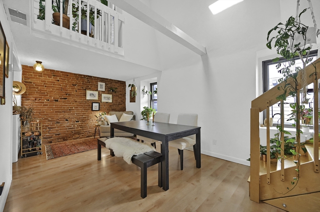 a view of a livingroom with furniture window and wooden floor