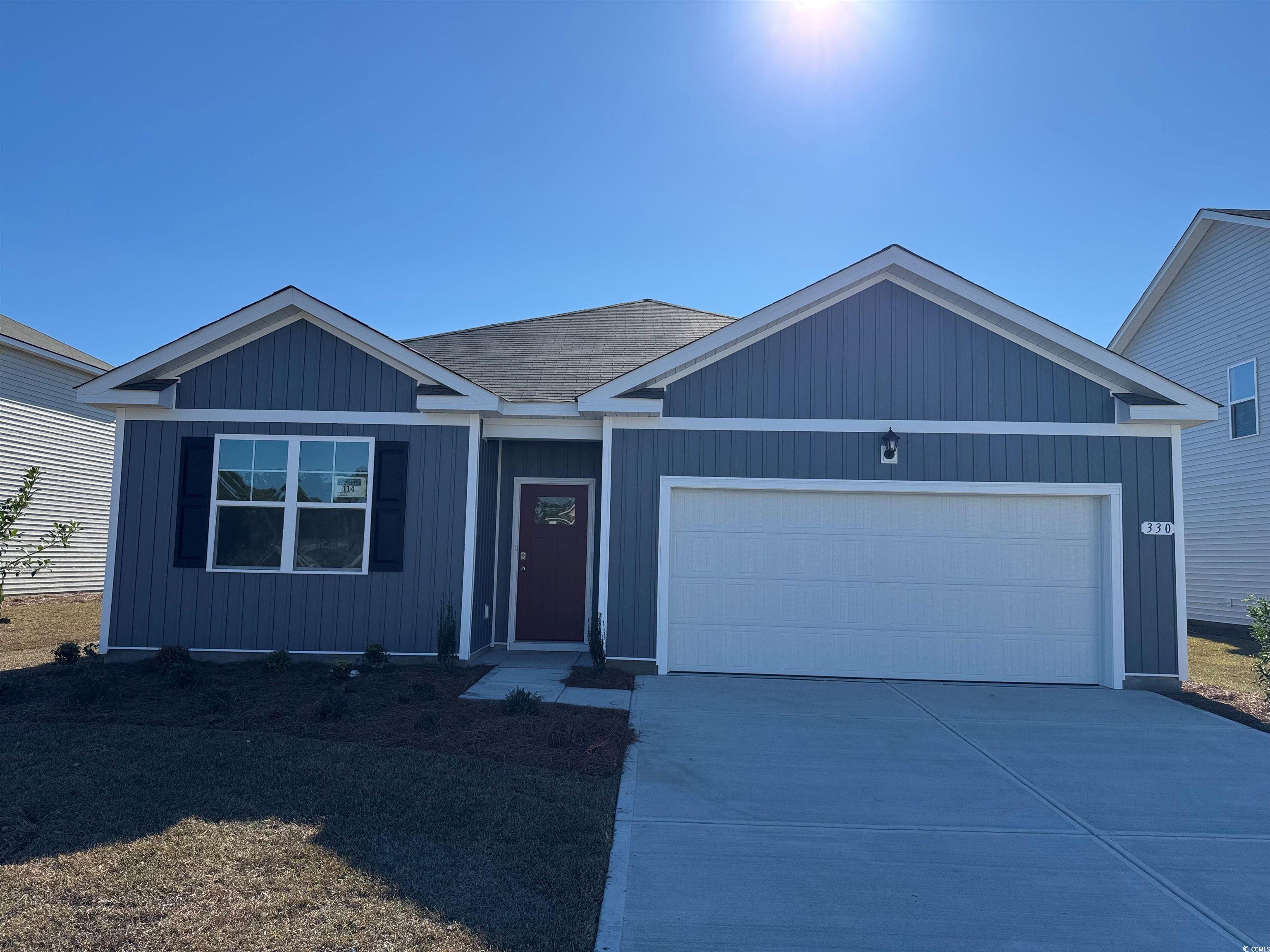 View of front of property featuring a garage