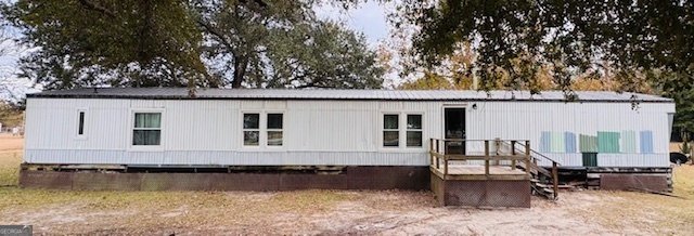 a front view of a house with swimming pool and sitting area