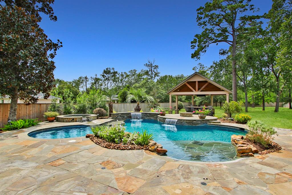 Imagine yourself enjoying this one of a kind backyard view!  Gorgeous custom pool and outdoor kitchen, lush landscaping, mature trees and natural beauty as far as the eye can see!