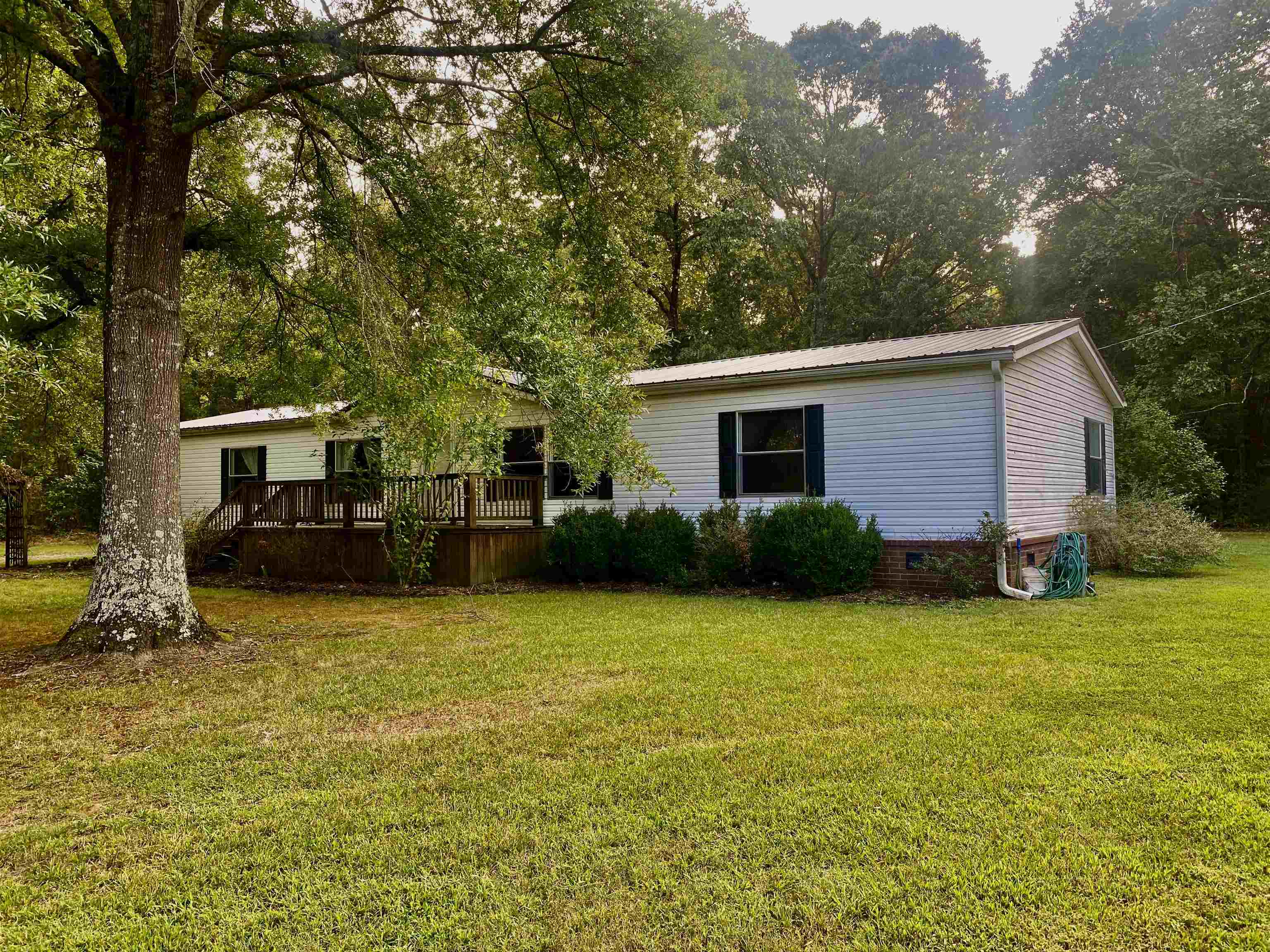 a front view of house with yard and trees