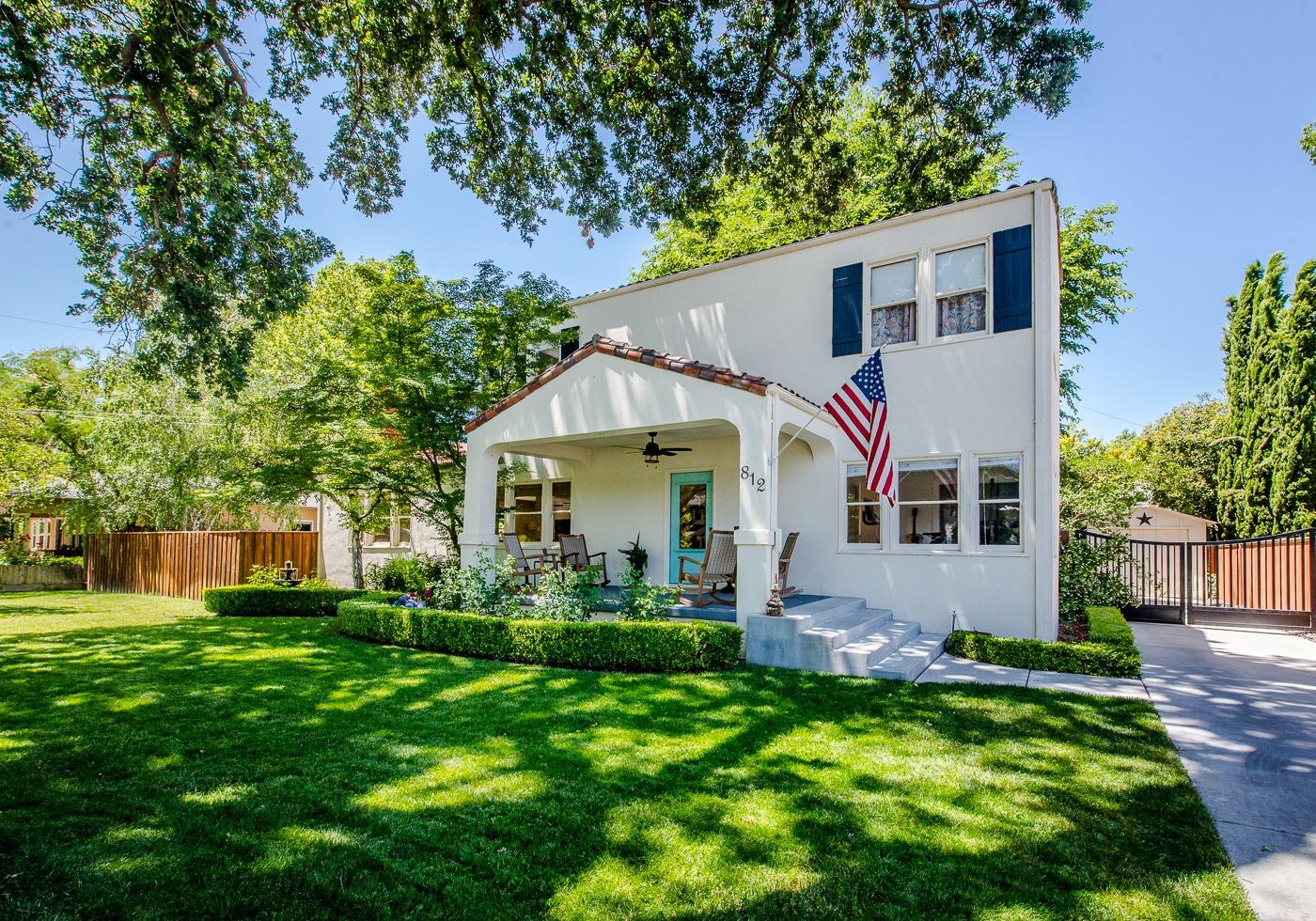 a front view of house with yard and green space