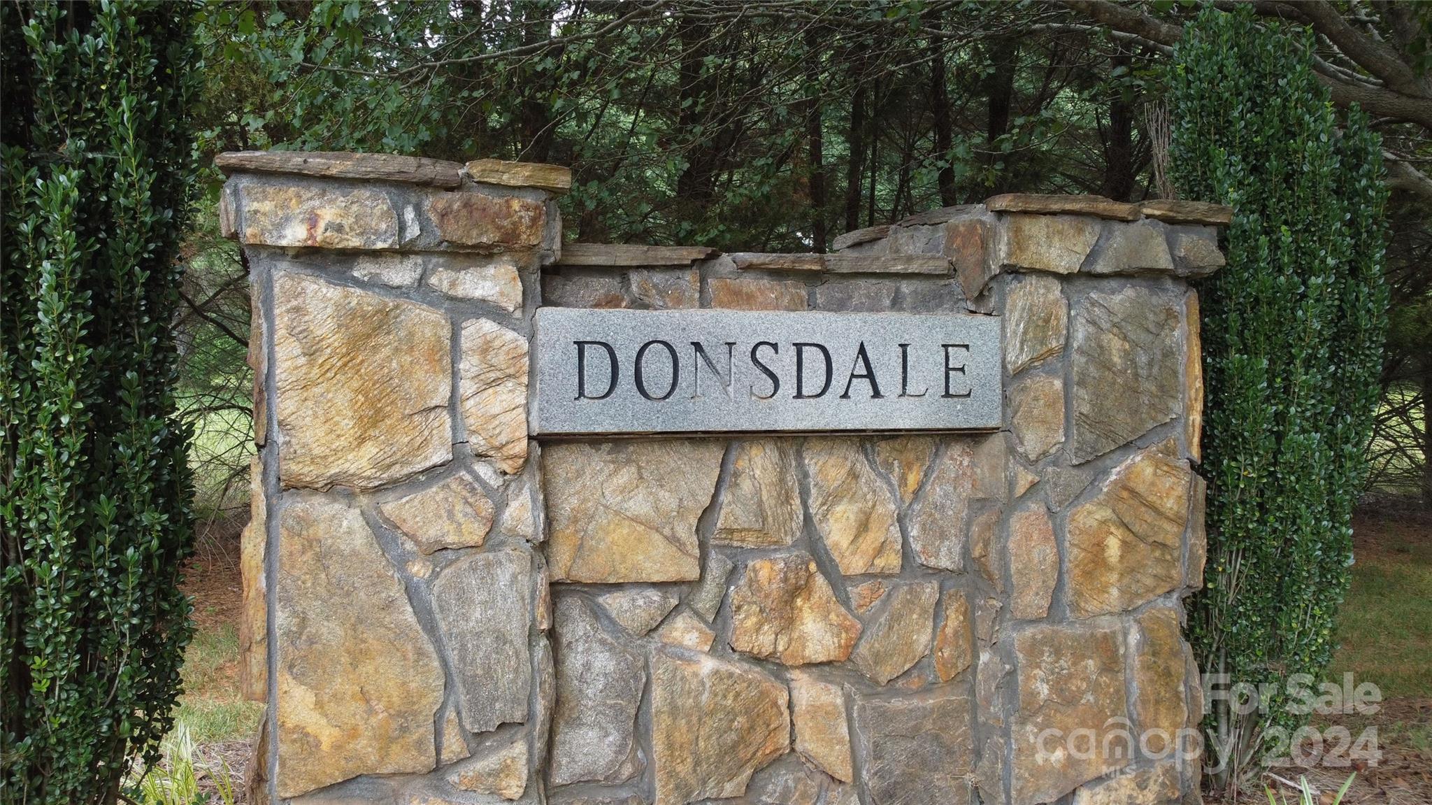 a view of outdoor space with sign board and trees