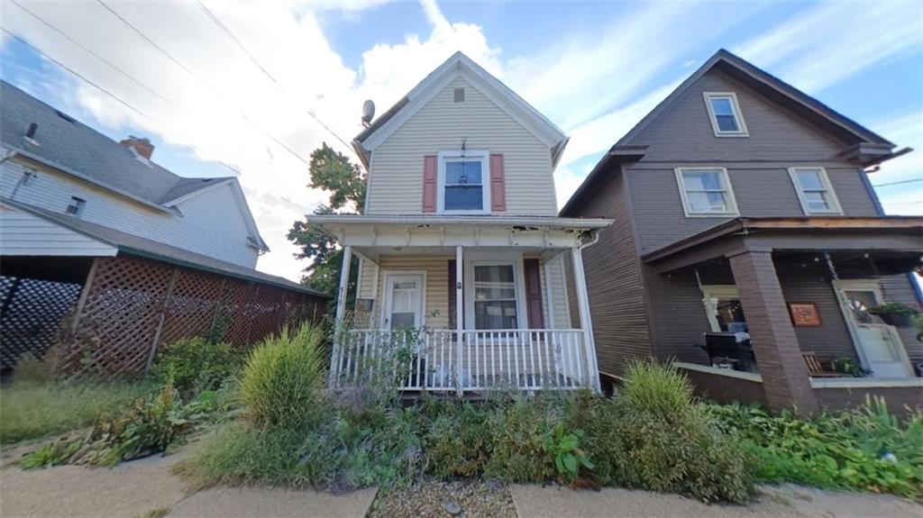 a front view of a house with plants