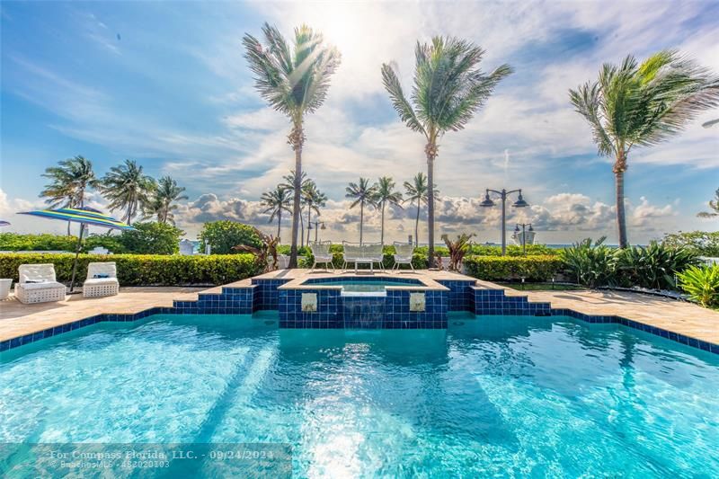 a view of yard with swimming pool and tall trees