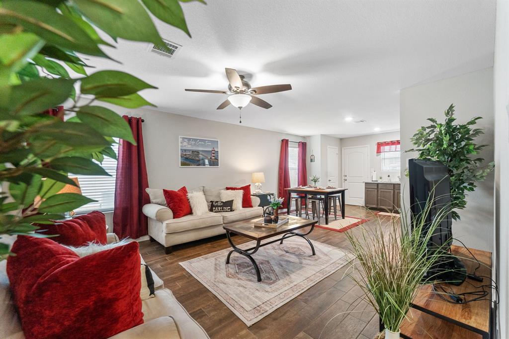 a living room with furniture flower pot and a fireplace