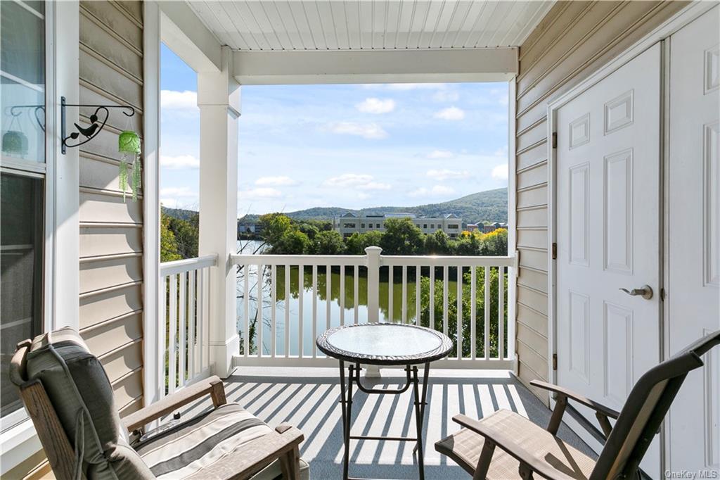 Balcony featuring a mountain and pond views!