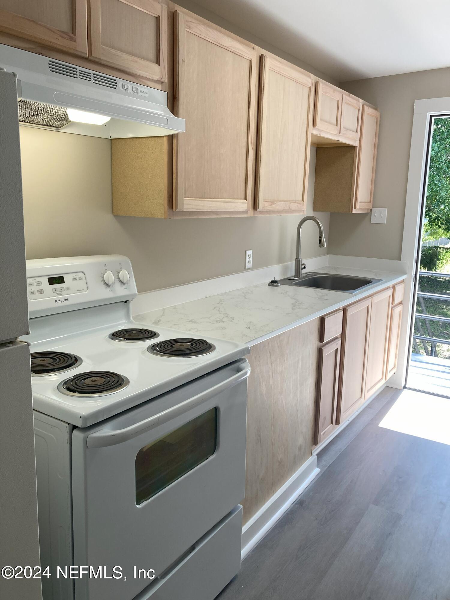 a kitchen with a stove and a sink