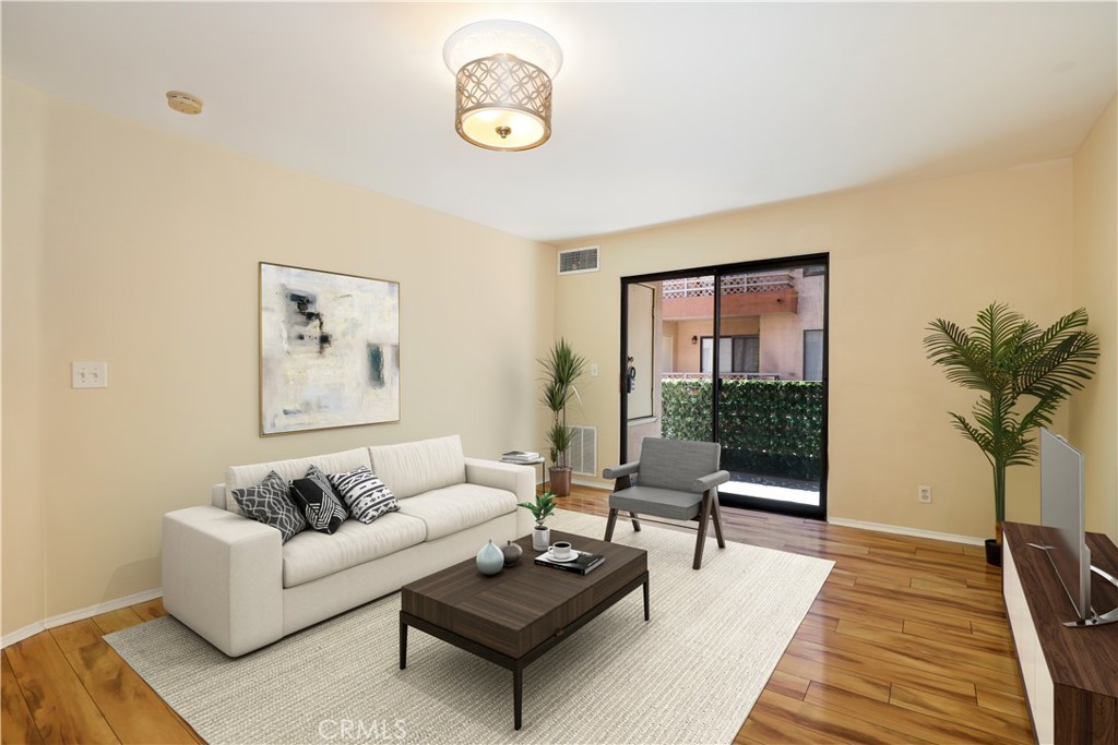 a living room with furniture and a potted plant