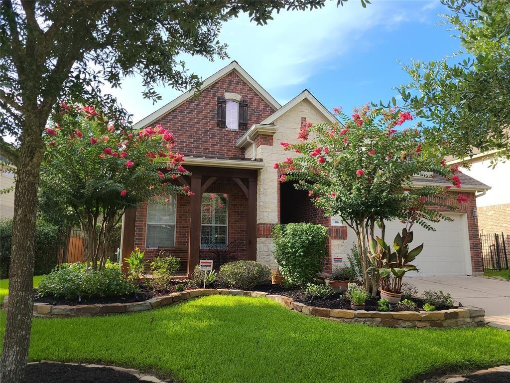 a front view of house with a yard and trees