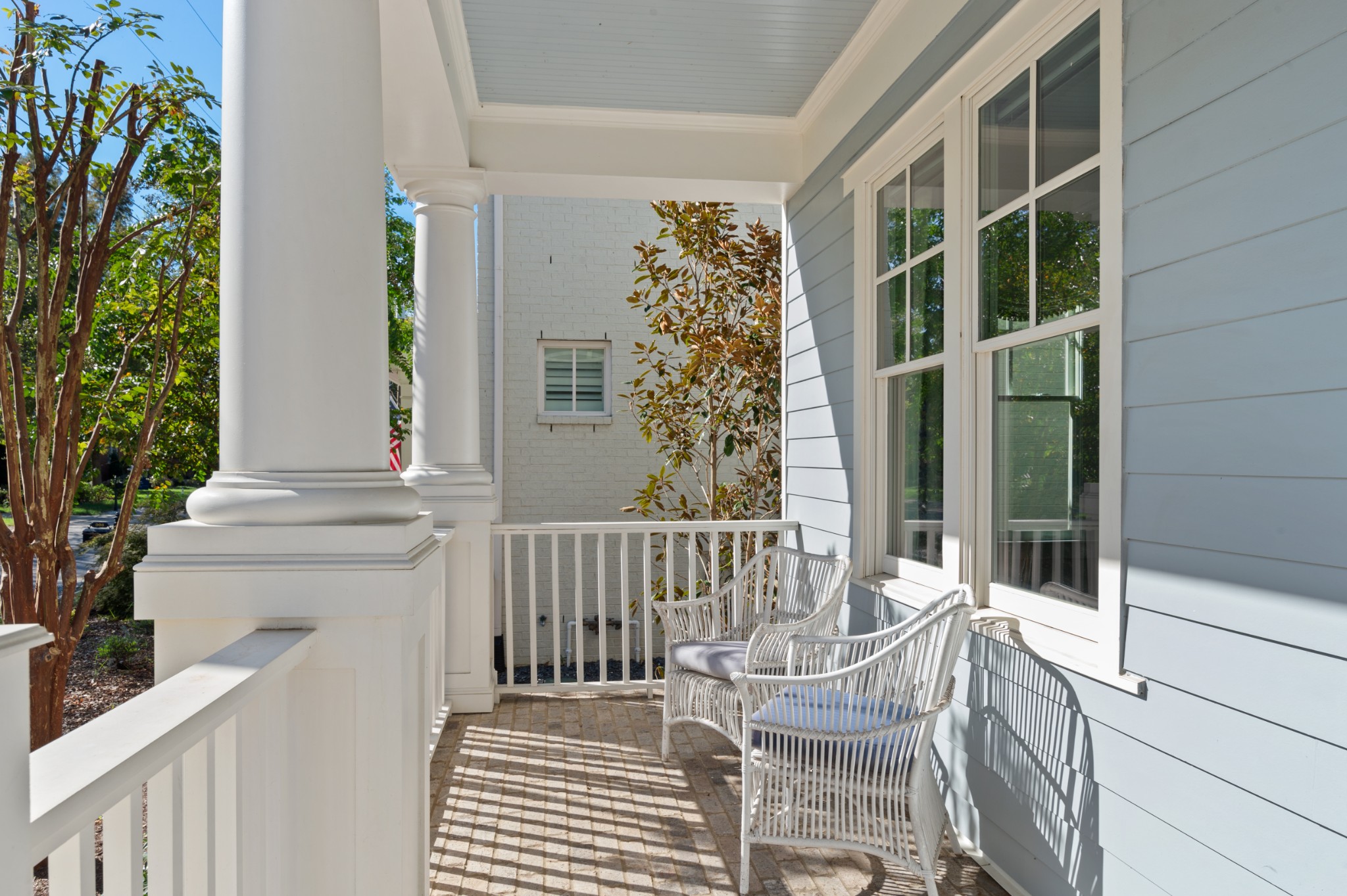 a view of balcony with two chairs and a potted plant