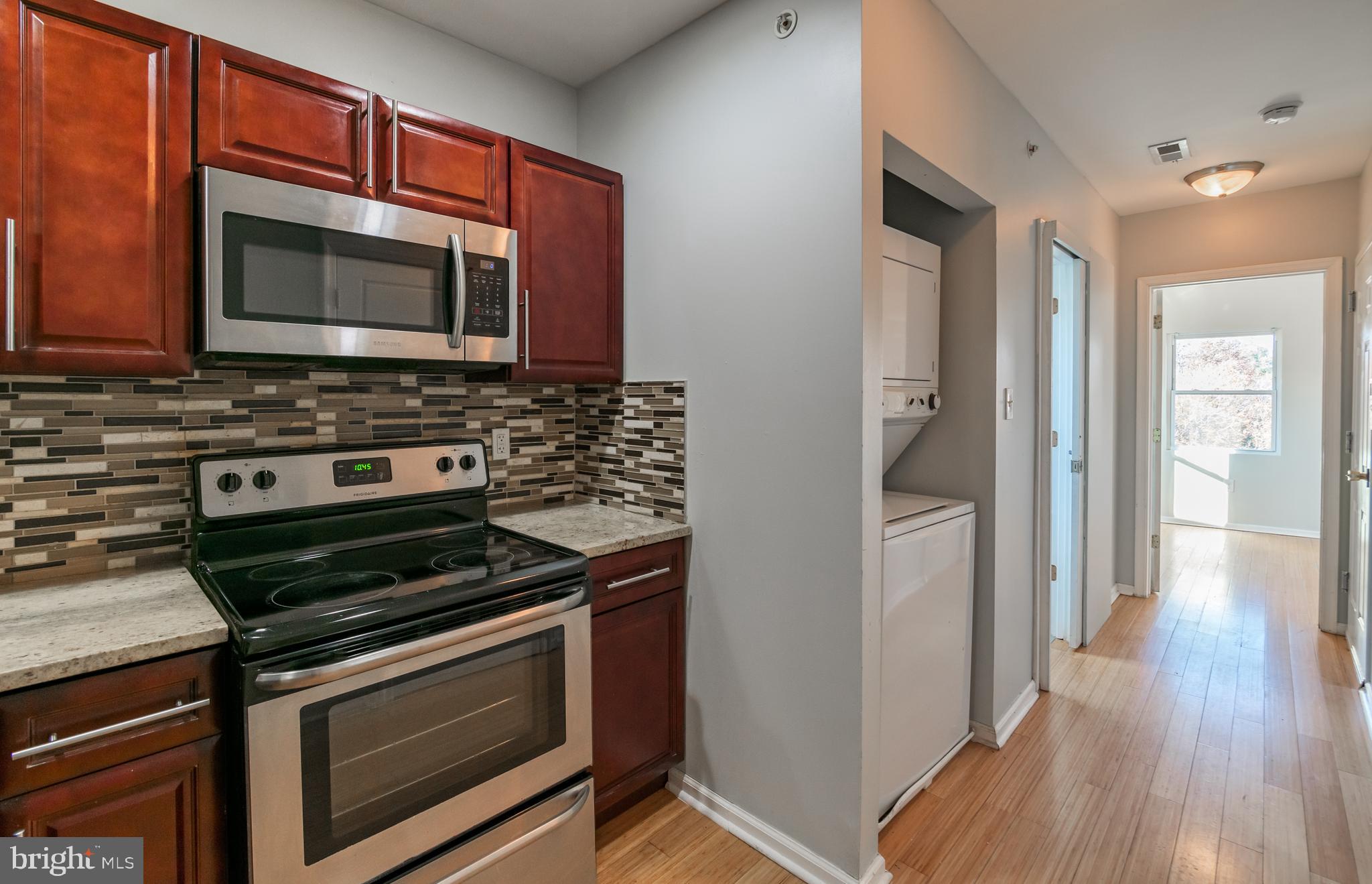 a kitchen with stainless steel appliances a stove microwave and sink