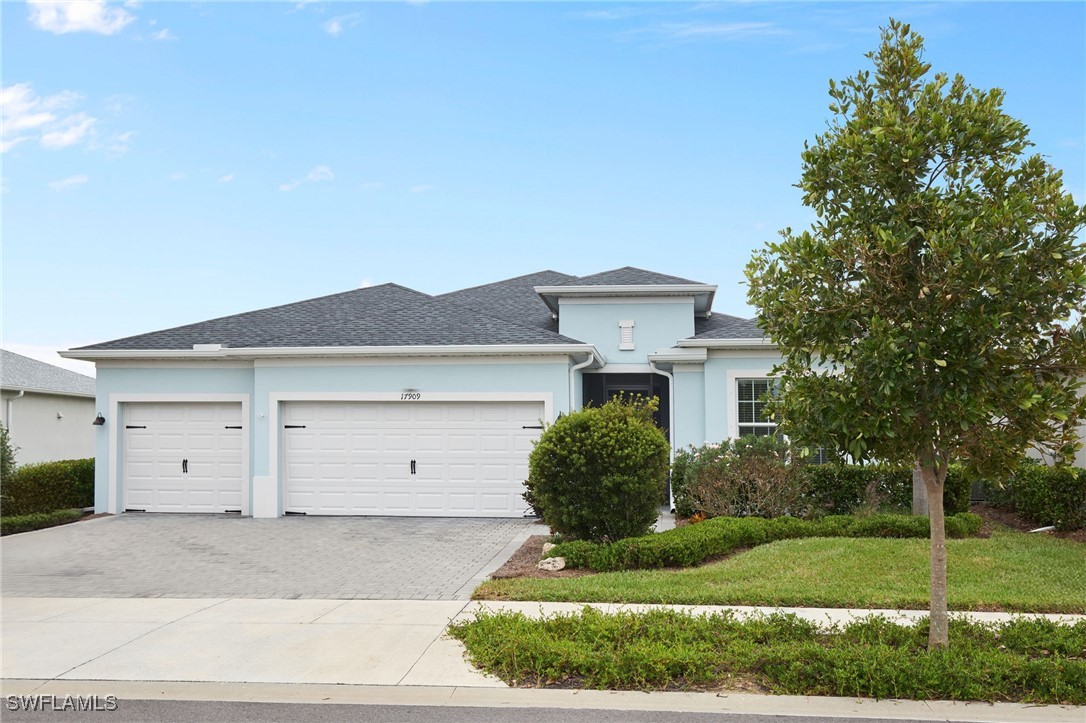 a front view of a house with a yard and garage