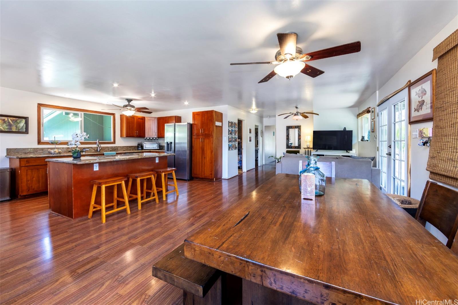 an open kitchen with wooden floor and large kitchen view