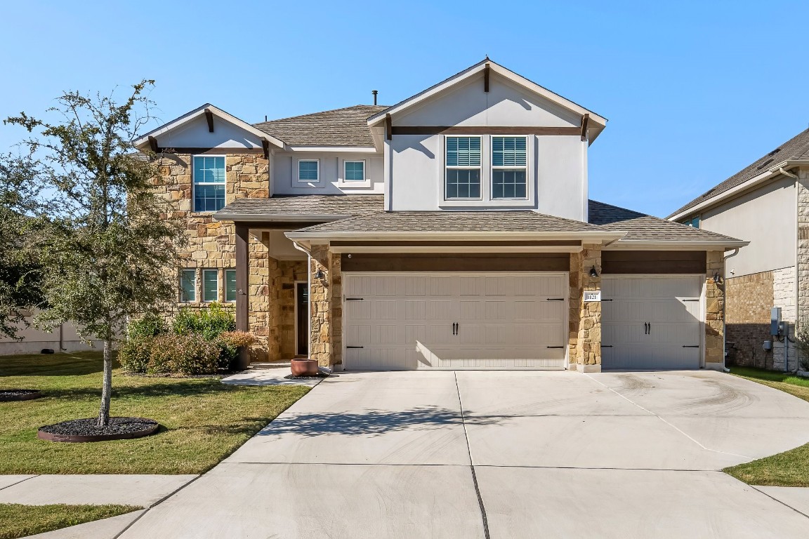 a front view of a house with a yard and garage