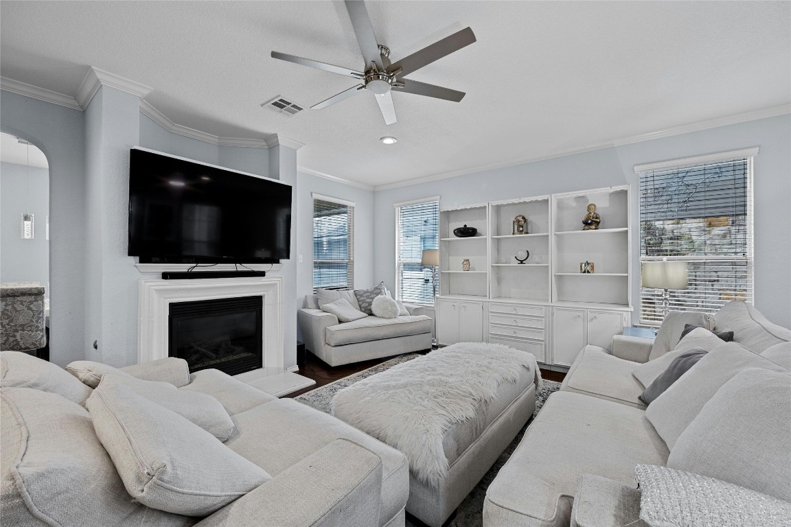 a living room with furniture a flat screen tv and a fireplace