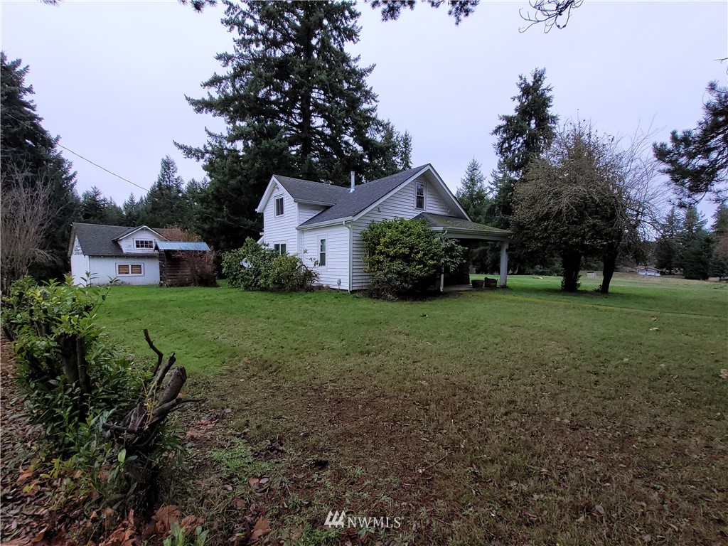 a view of a house with yard and a garden