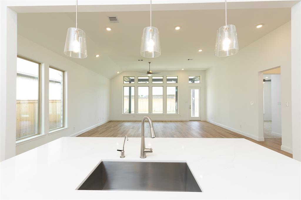 a view of a room with kitchen and windows