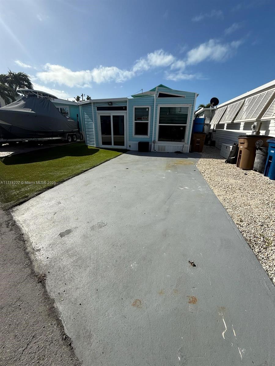 a view of house with yard and entertaining space