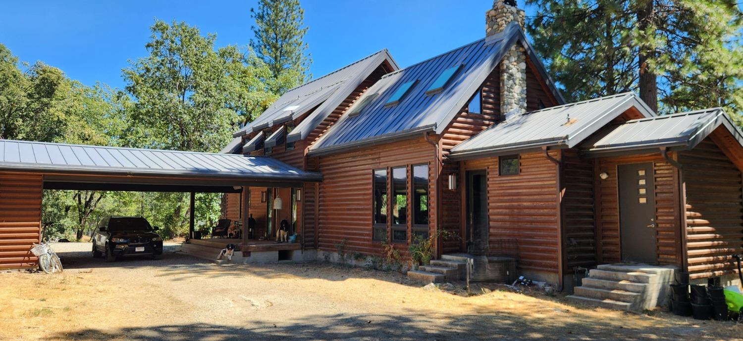 a view of a house with backyard porch and sitting area