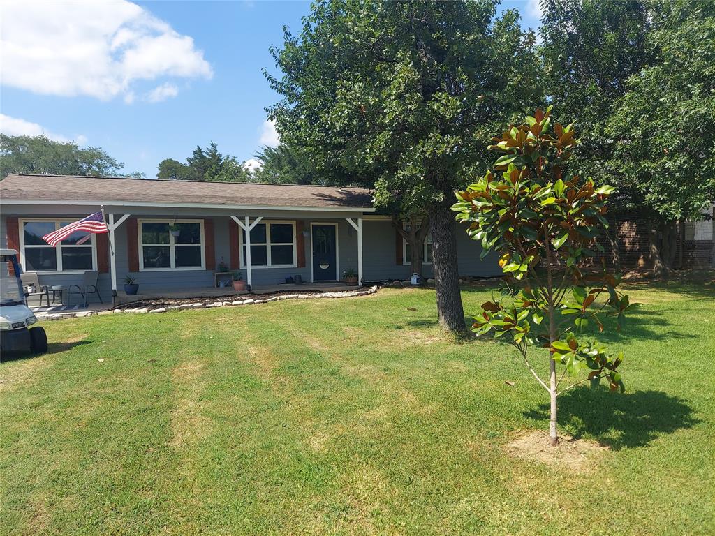 a view of a house with a backyard