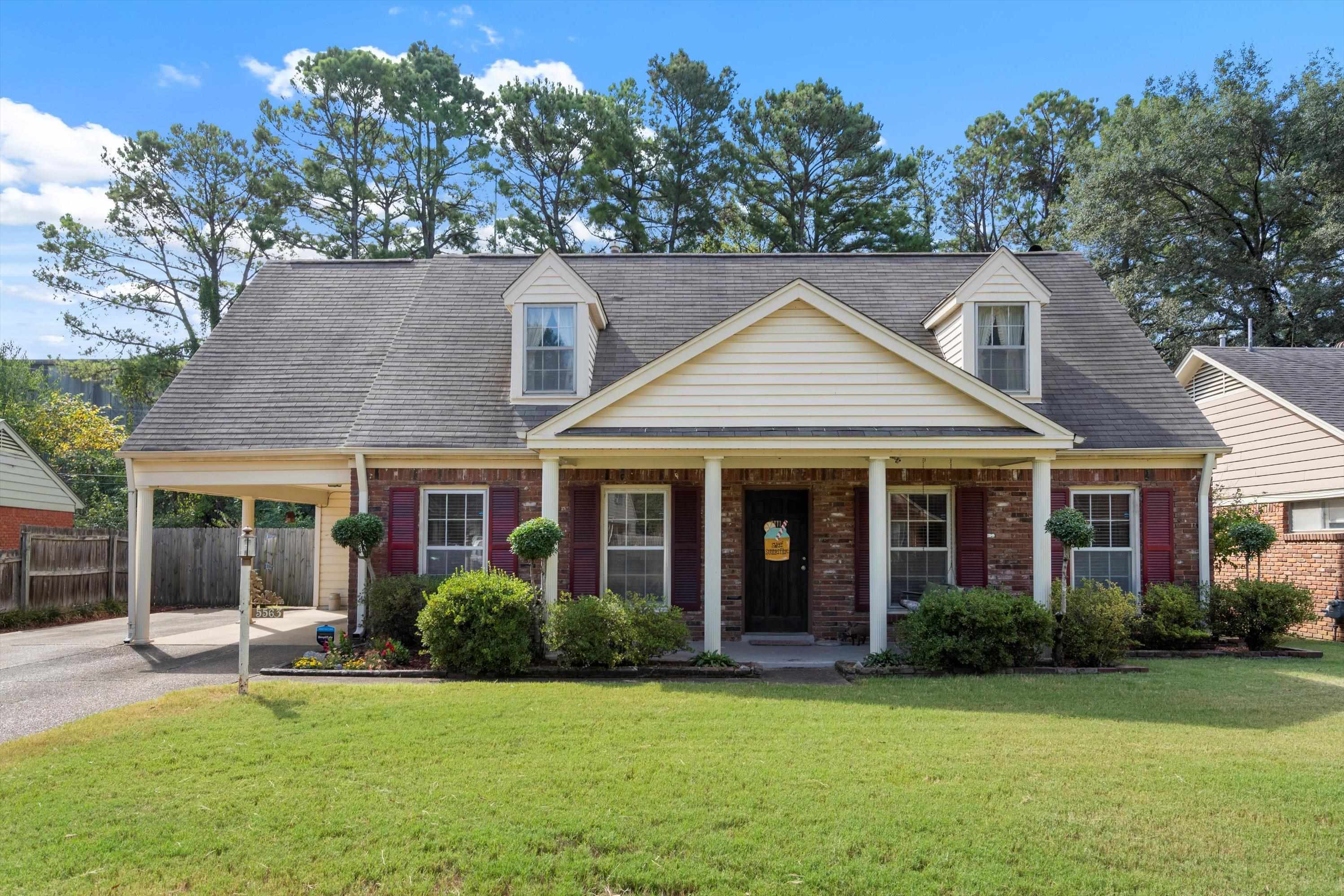 Cape cod-style house featuring a porch and a front yard