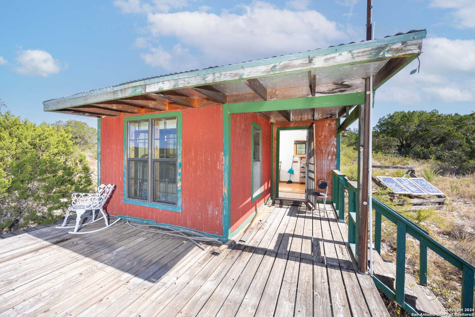 a view of a porch with wooden floor and furniture