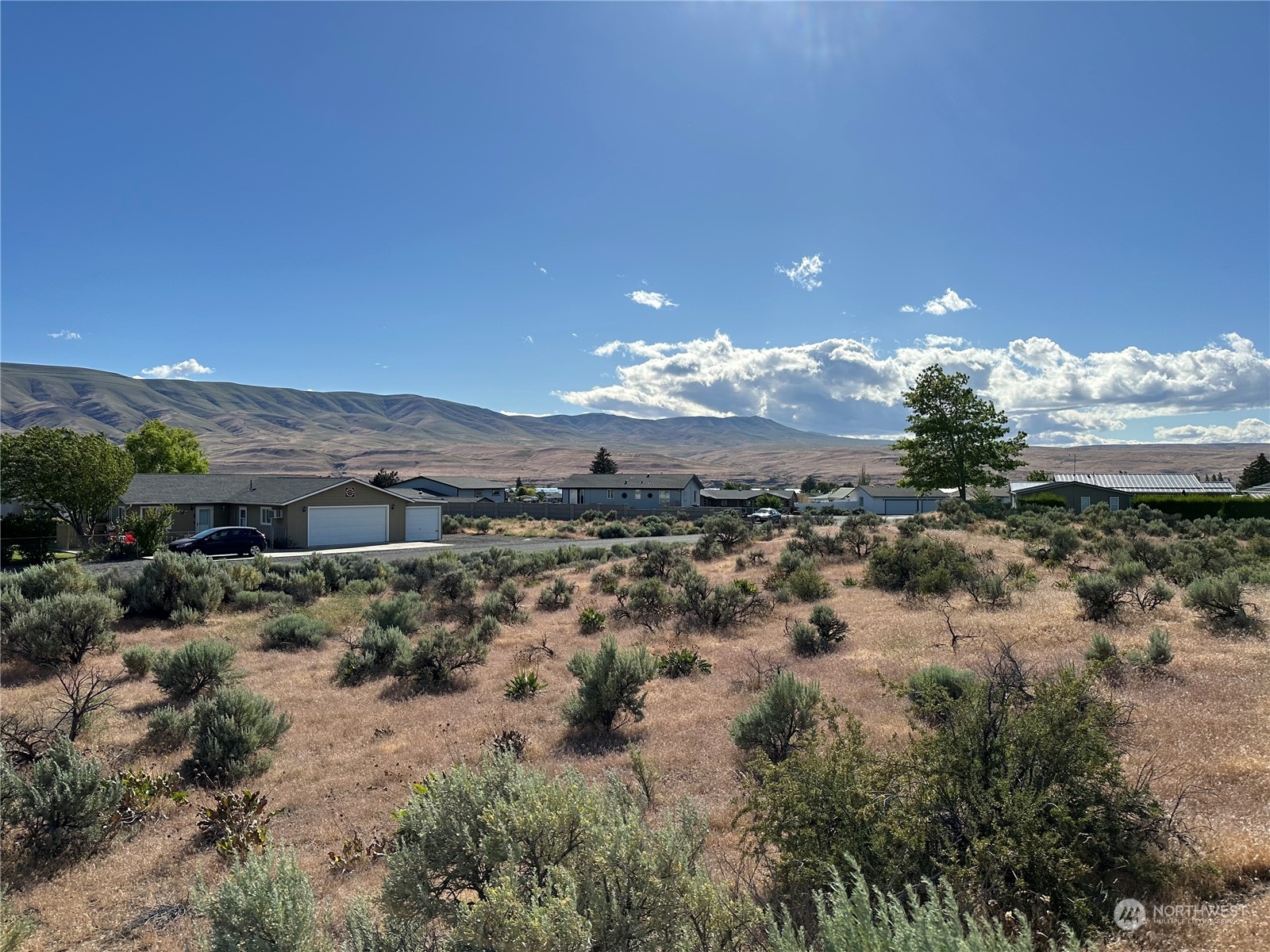 a view of a town with mountains in the background