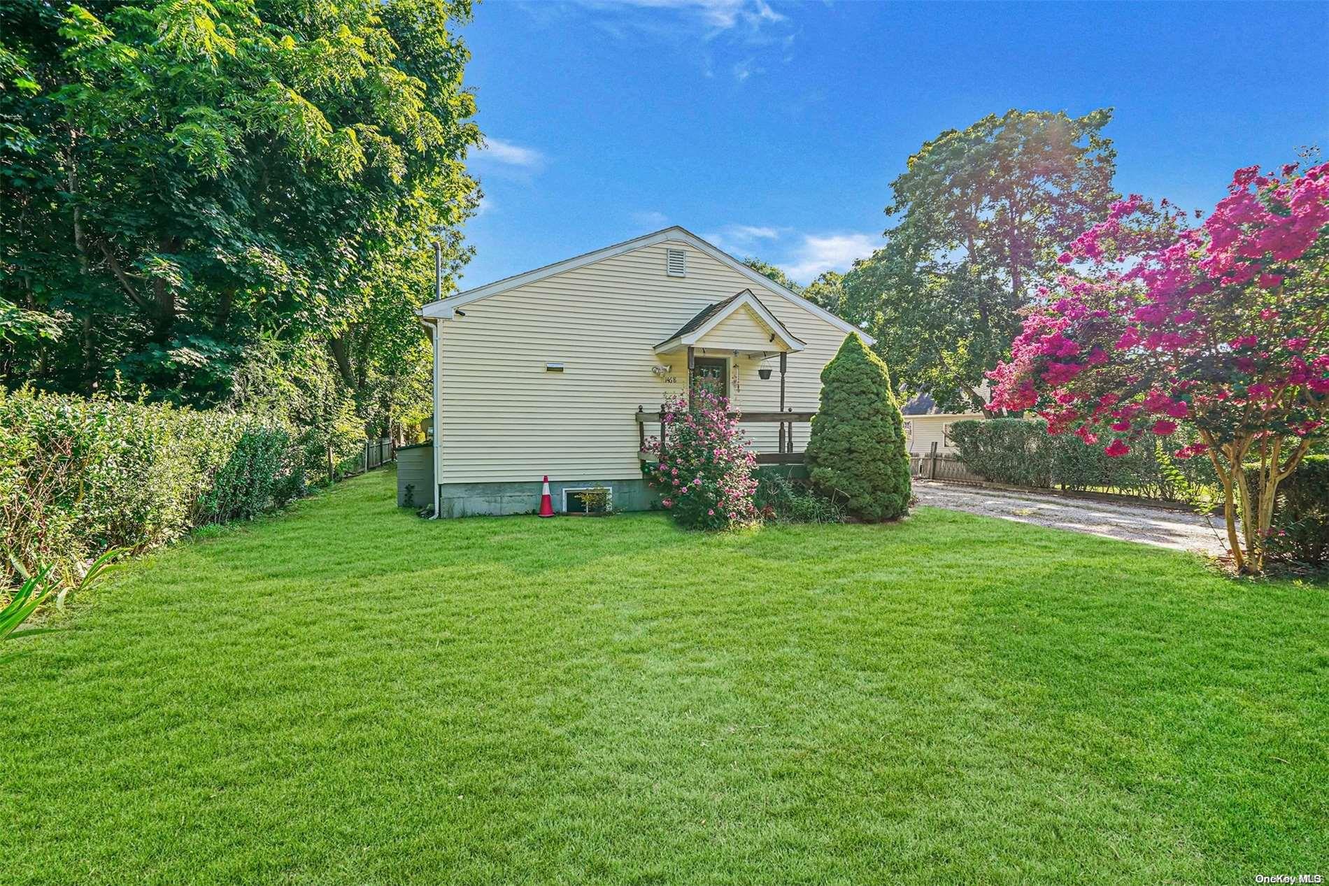 a view of a house with a yard and garden